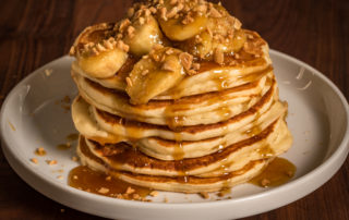 Stack of pancakes with banana and caramel